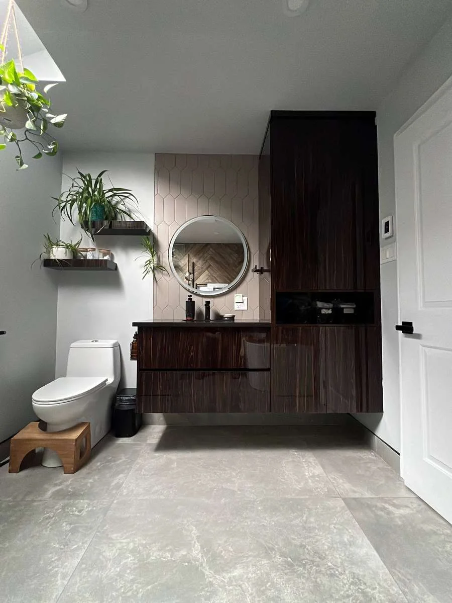 Wall mounted dark wood bathroom vanity with a round mirror and a full height storage tower, by Limakdeco